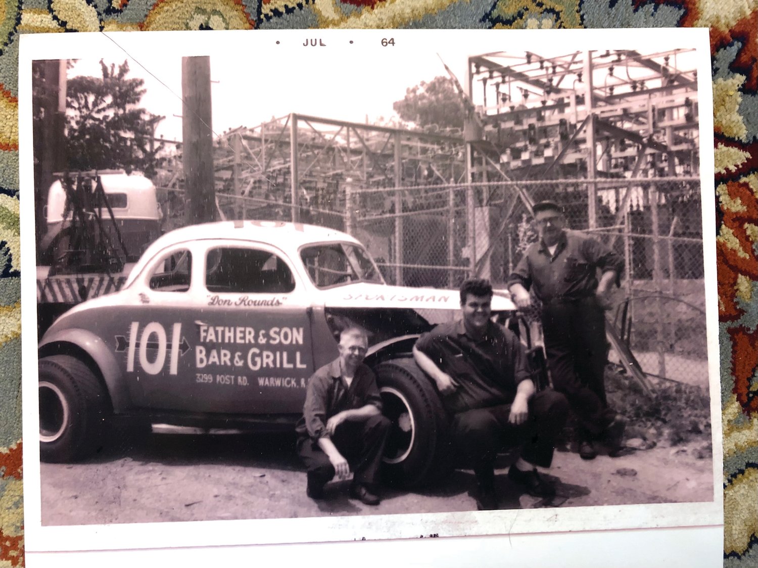 Harold Rounds, family friend “Big Wayne” Voelker, and Lewis Rounds with the historic 101 at the Apponaug Garage on Post Road.